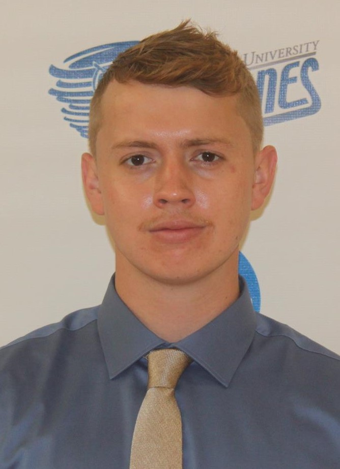 Justin Ruiz (head and shoulders mug shot in a blue shirt and gold tie on a Centenary Cyclones background)