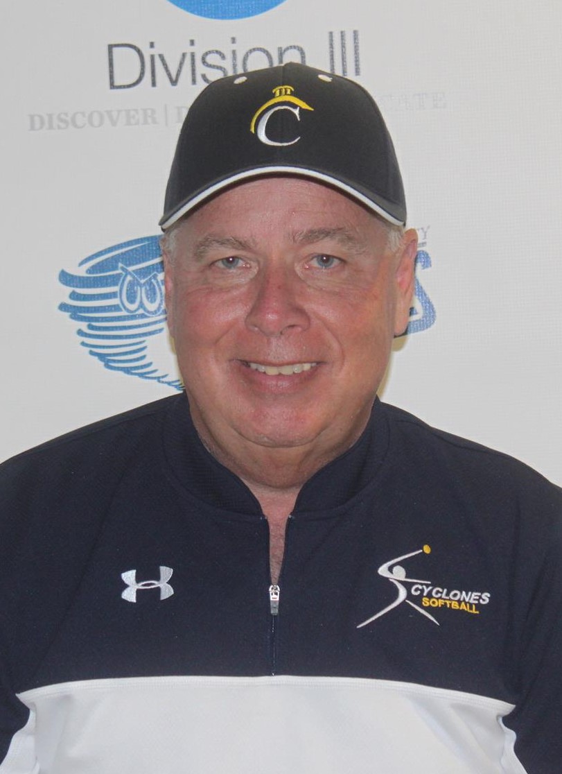 Len Kunz (head and shoulder mug shot in a blue Centenary baseball hat and blue and white pullover with Centenary softball text and an underarmour logo on it)