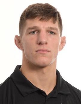 Gino Flurri Headshot (head and shoulders mug shot in a black golf shirt on a white background)