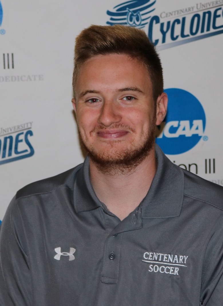 Nik Polizos (head and shoulders mug shot in a gray polo shirt that says Centenary soccer)