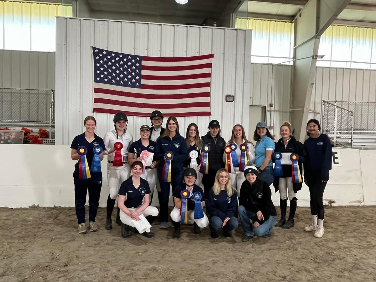 Group photo of Centenary IDA team coach and riders holding ribbons from their Oct 19th Home Show