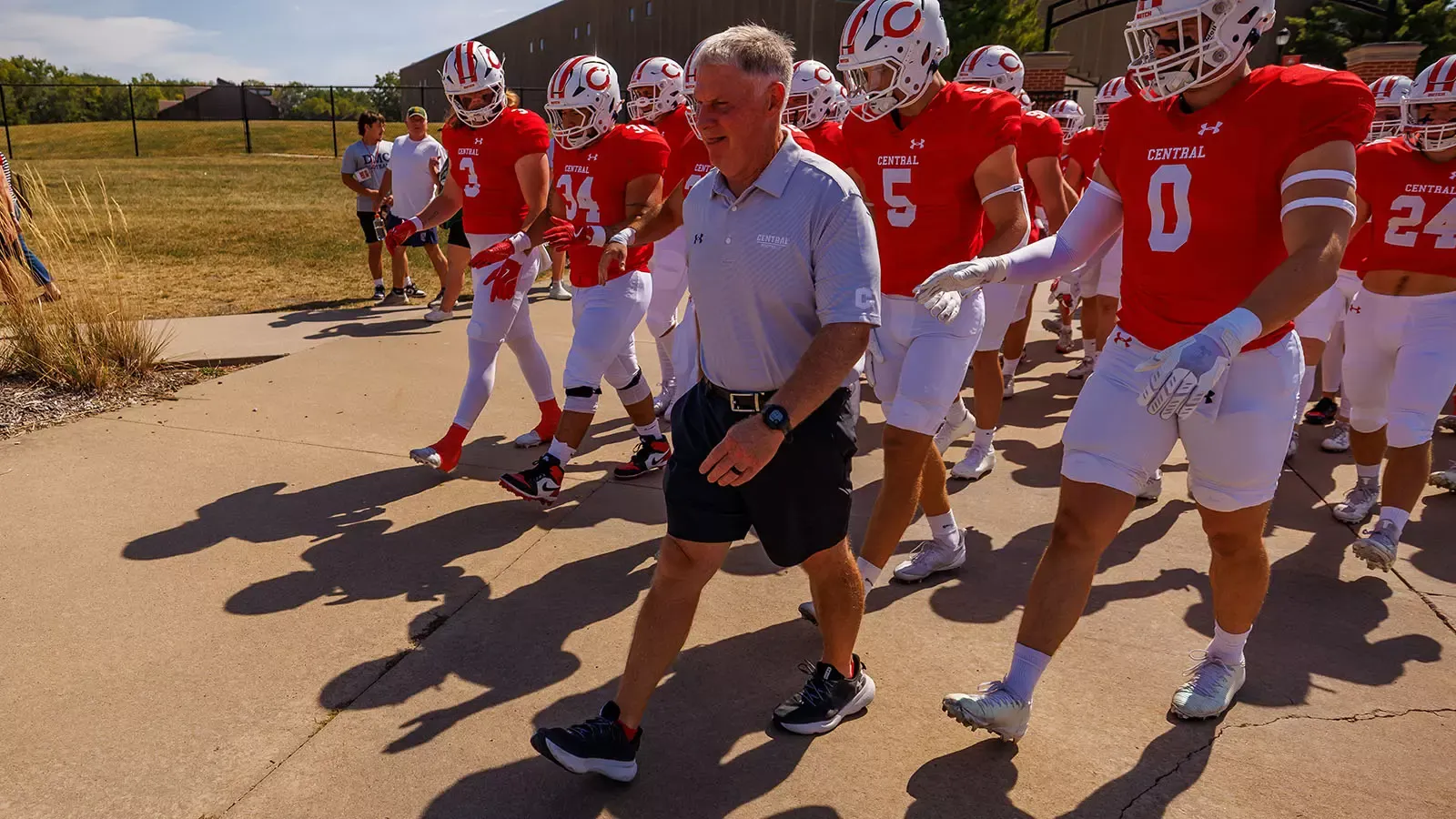 Coach Jones leads the team onto the field