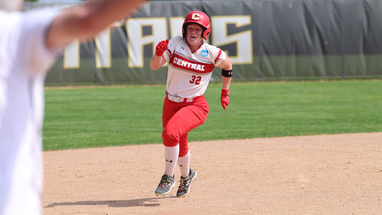 Hannah Higgins running between second base and third base