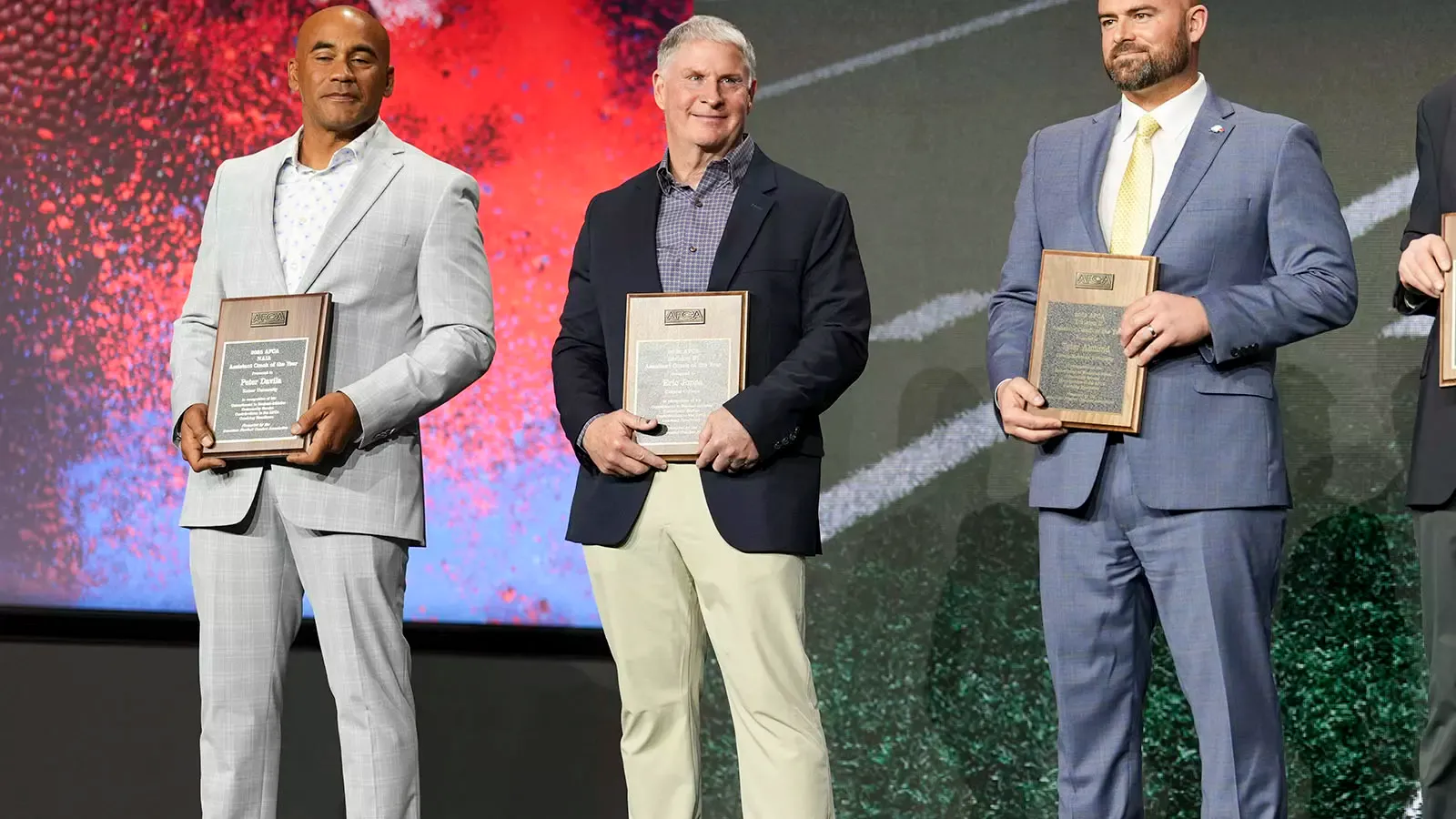 Assistant coach Eric Jones receiving his Division III Assistant Coach of the Year plaque at AFCA convention