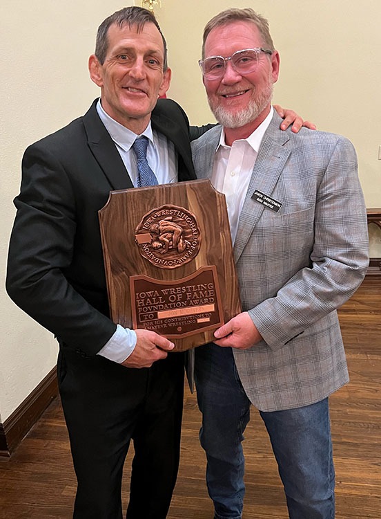 Jon McGovern holding Iowa Wrestling HOF Plaque with Jason Christenson