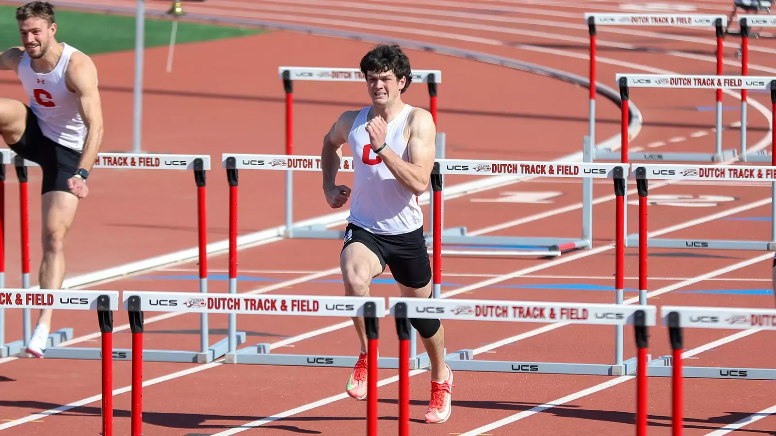 Kale Hobart running in between two hurdles