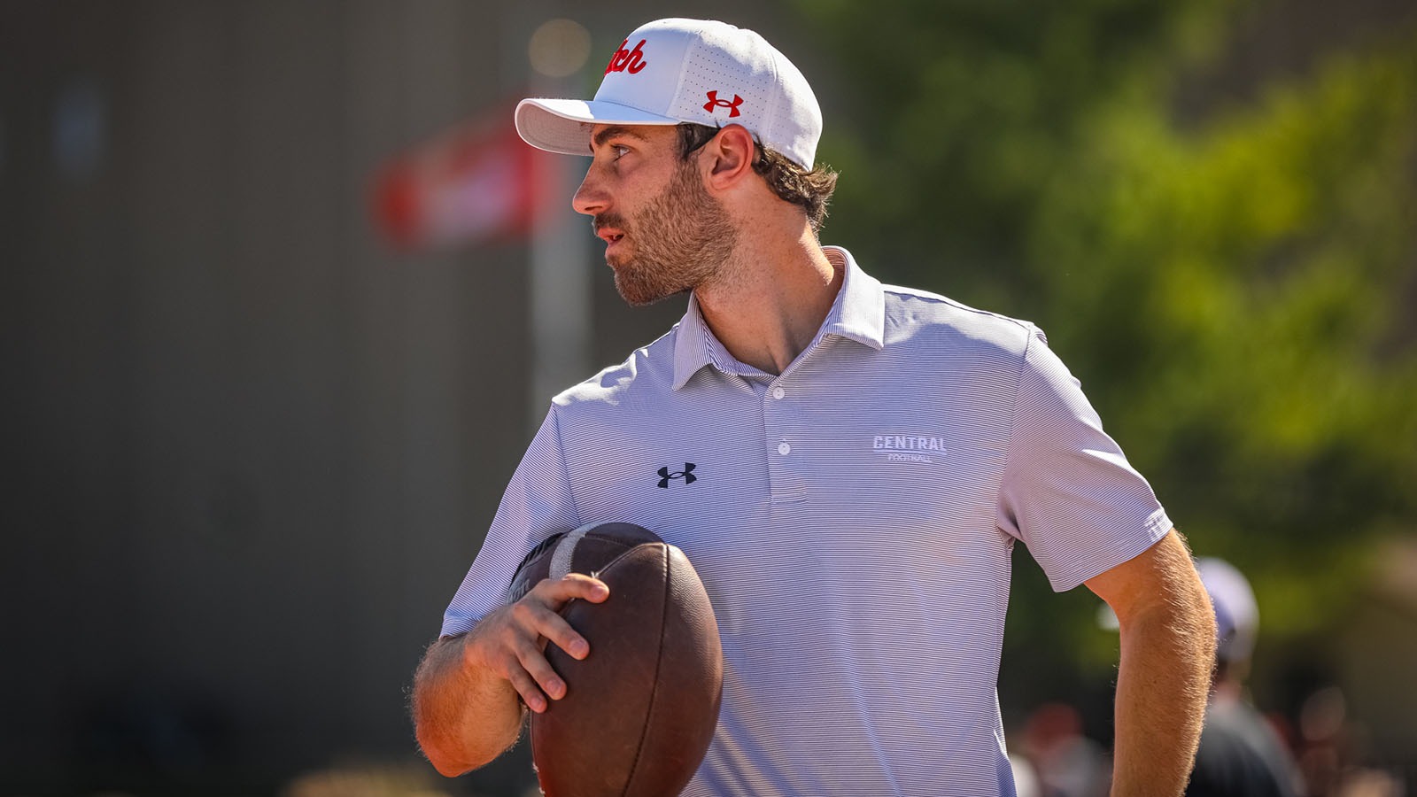 Owen Brase holding footballs during pre-game warmups