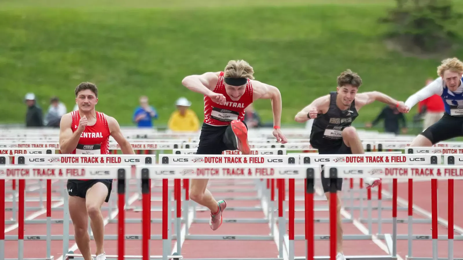 Gage Huyser jumping over a hurdle