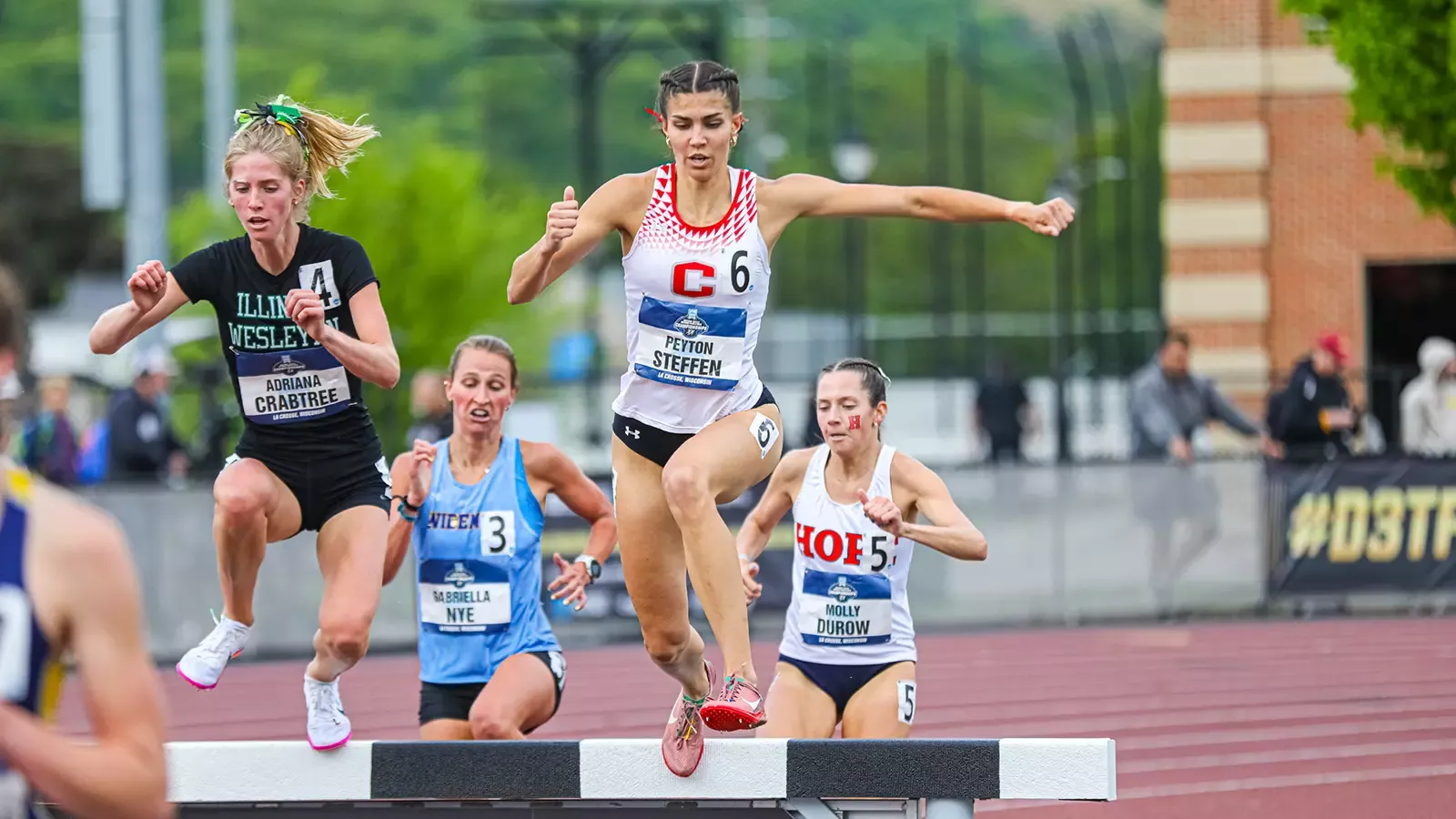 Peyton Steffen clearing the water hurdle on the steeplechase