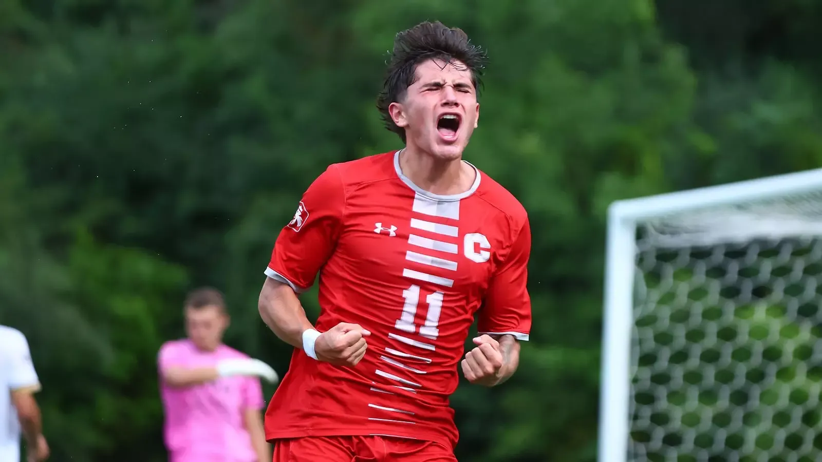 Isaiah Guyton celebrates a goal against St. Olaf