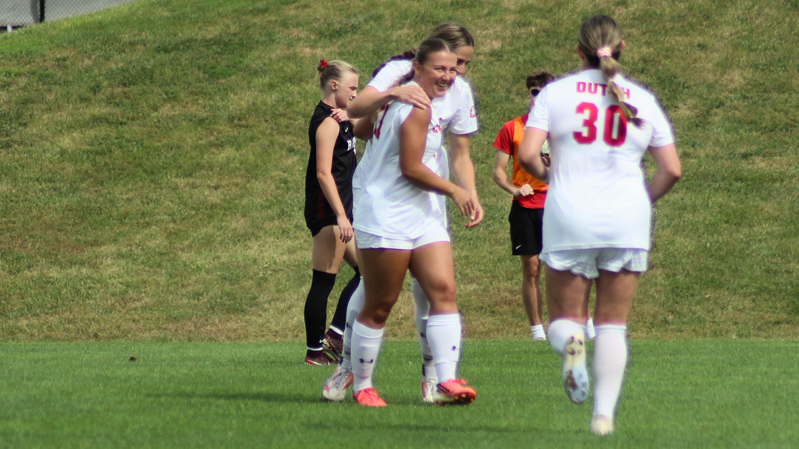 Olivia DeVos congratulated by teammates after scoring Saturday