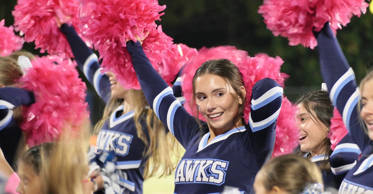 Darby Collins cheers during the pinkout football game at Charlotte Latin