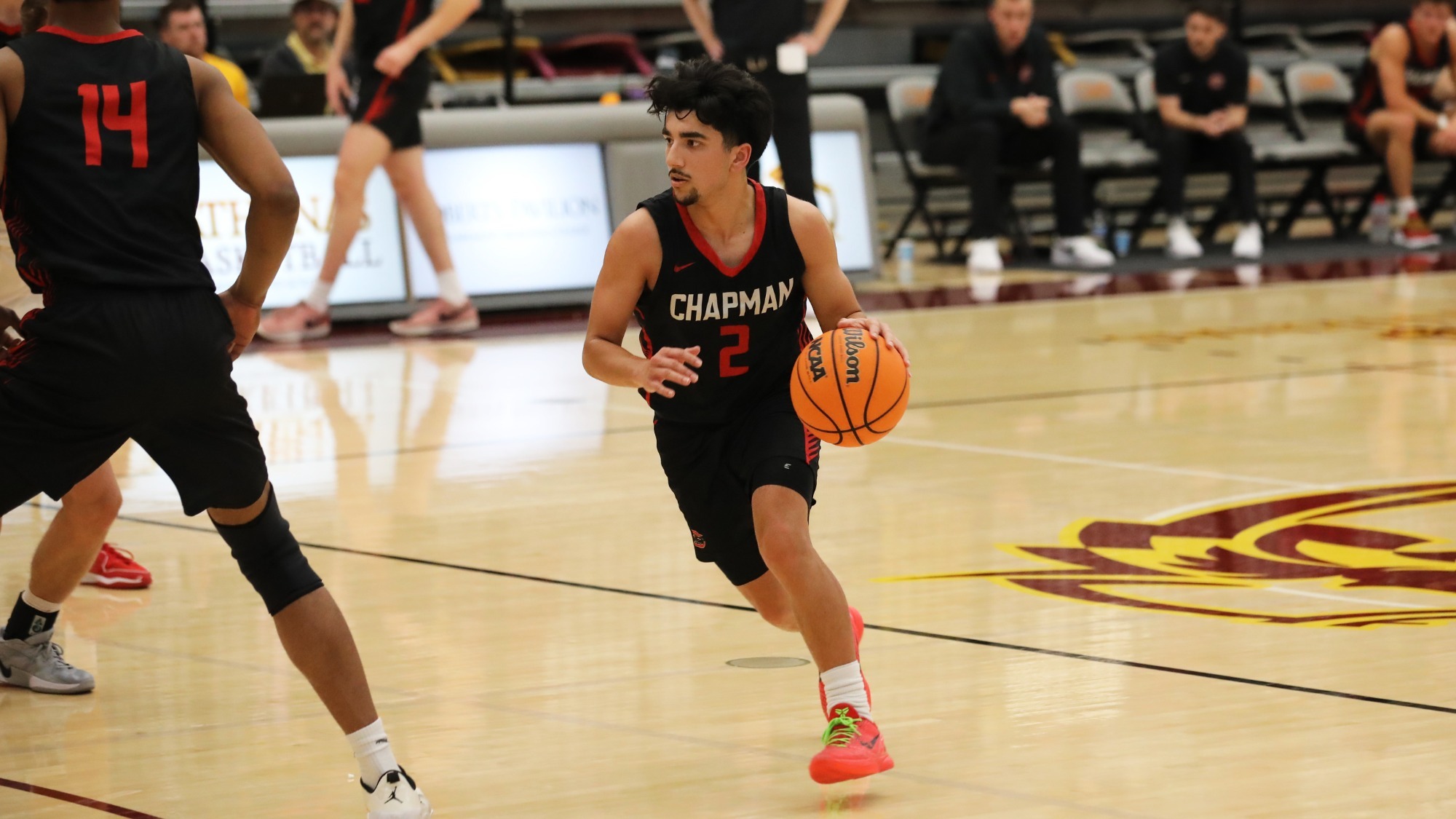 Cruz Billings dribbles on the basketball court.