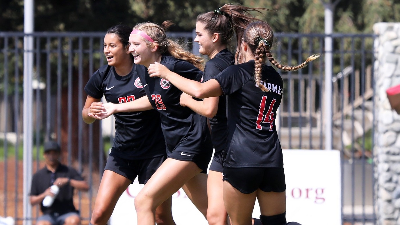 Four Chapman players celebrate a goal.