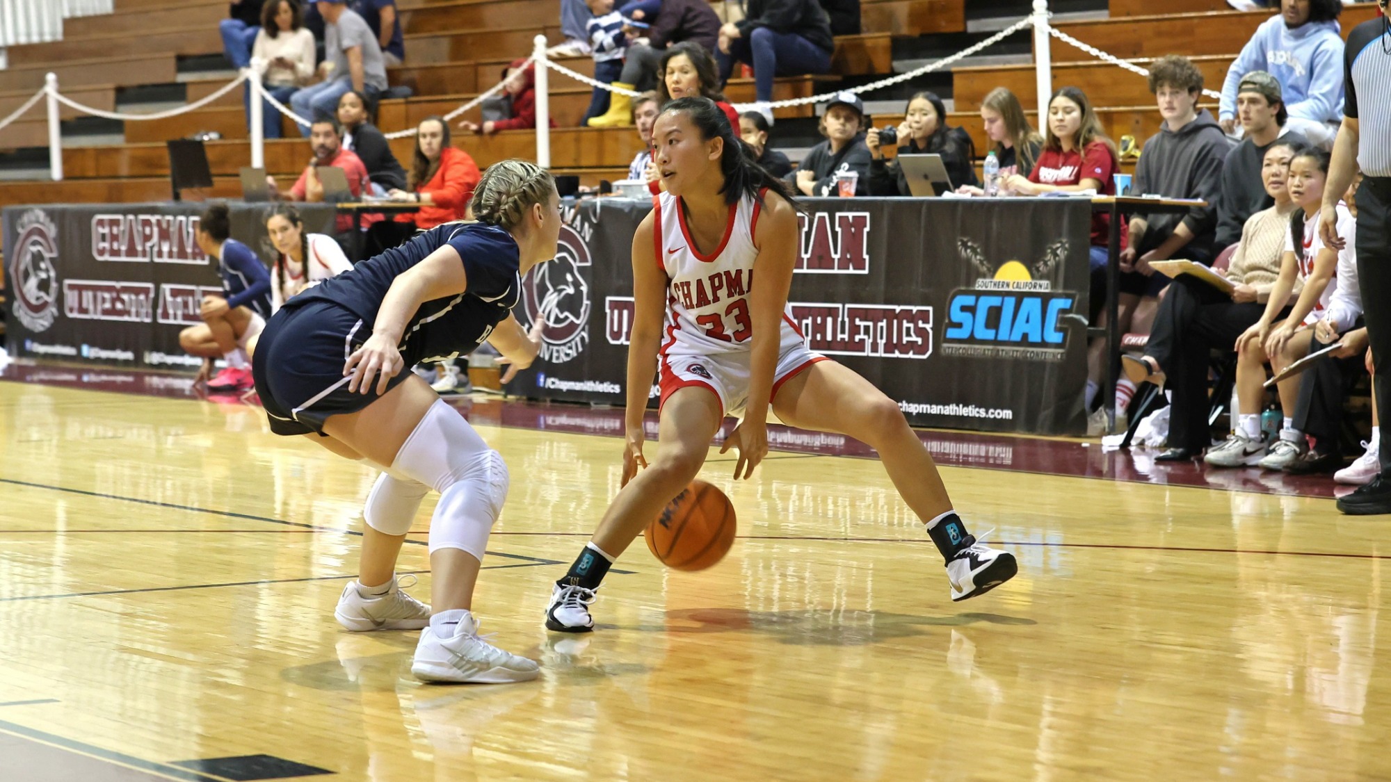 Maile Nakaji dribbles the basketball. 
