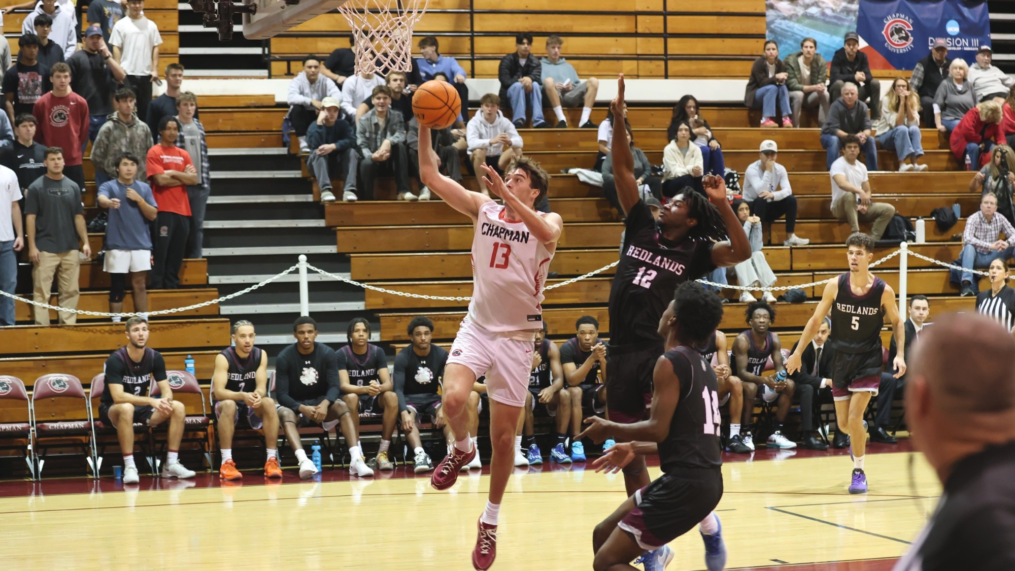 Jake Heberle jumps for a lay up on the basketball court.