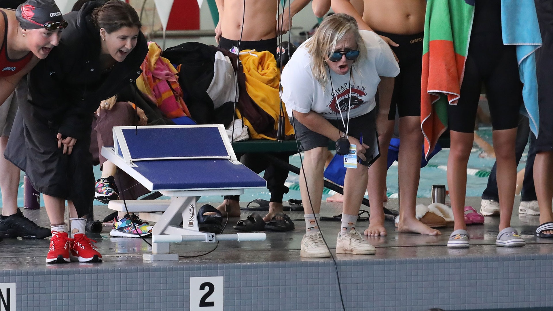 Carly Miller cheers on a swimmer.