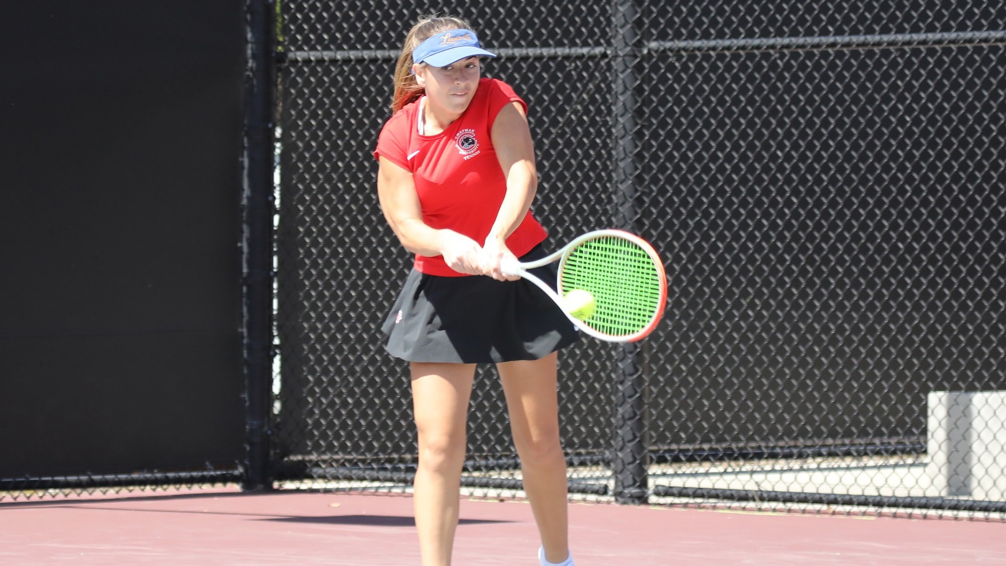 Chloe McBride hitting a tennis ball.