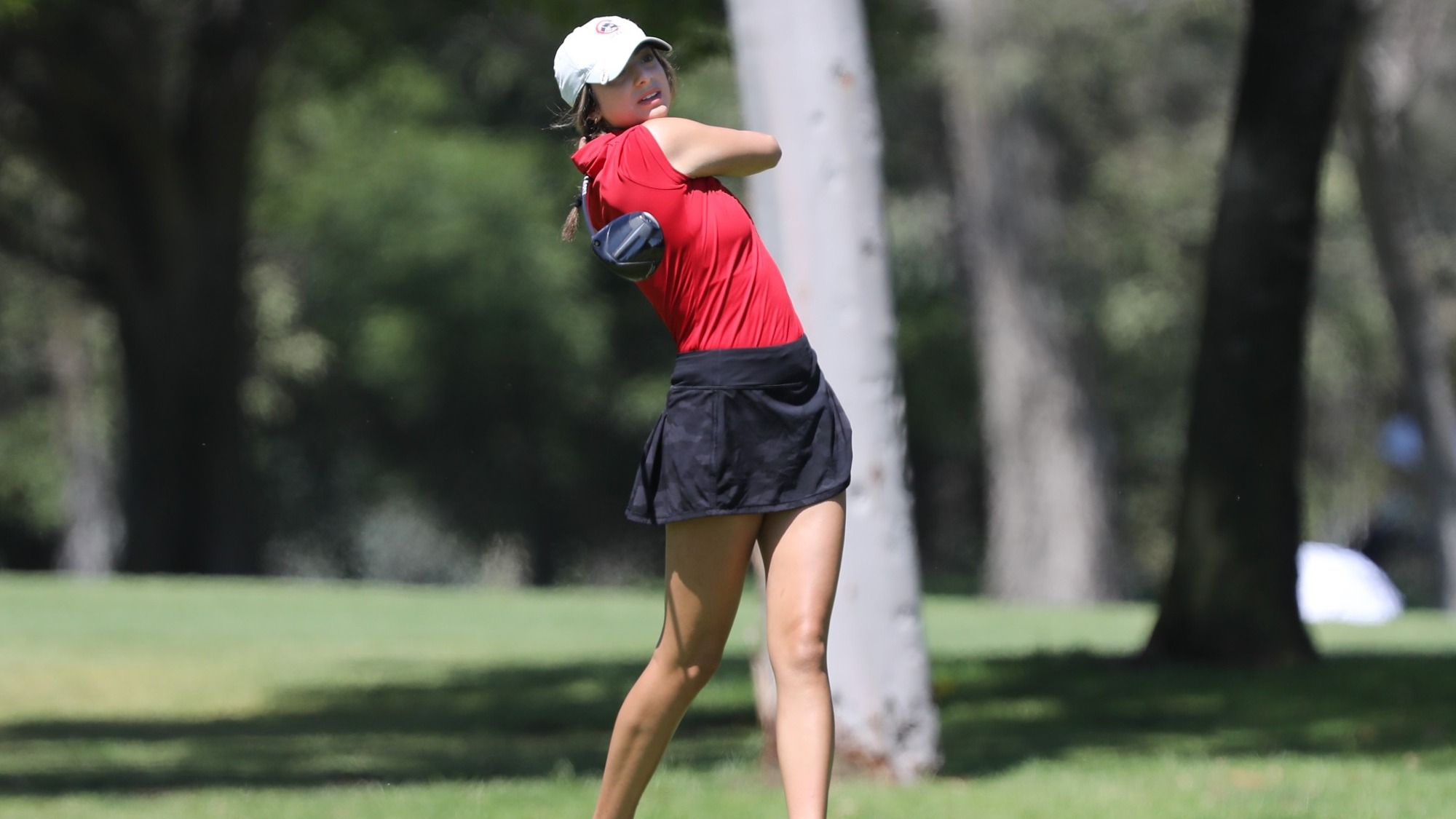Nika Gholami hits a tee shot on the golf course.