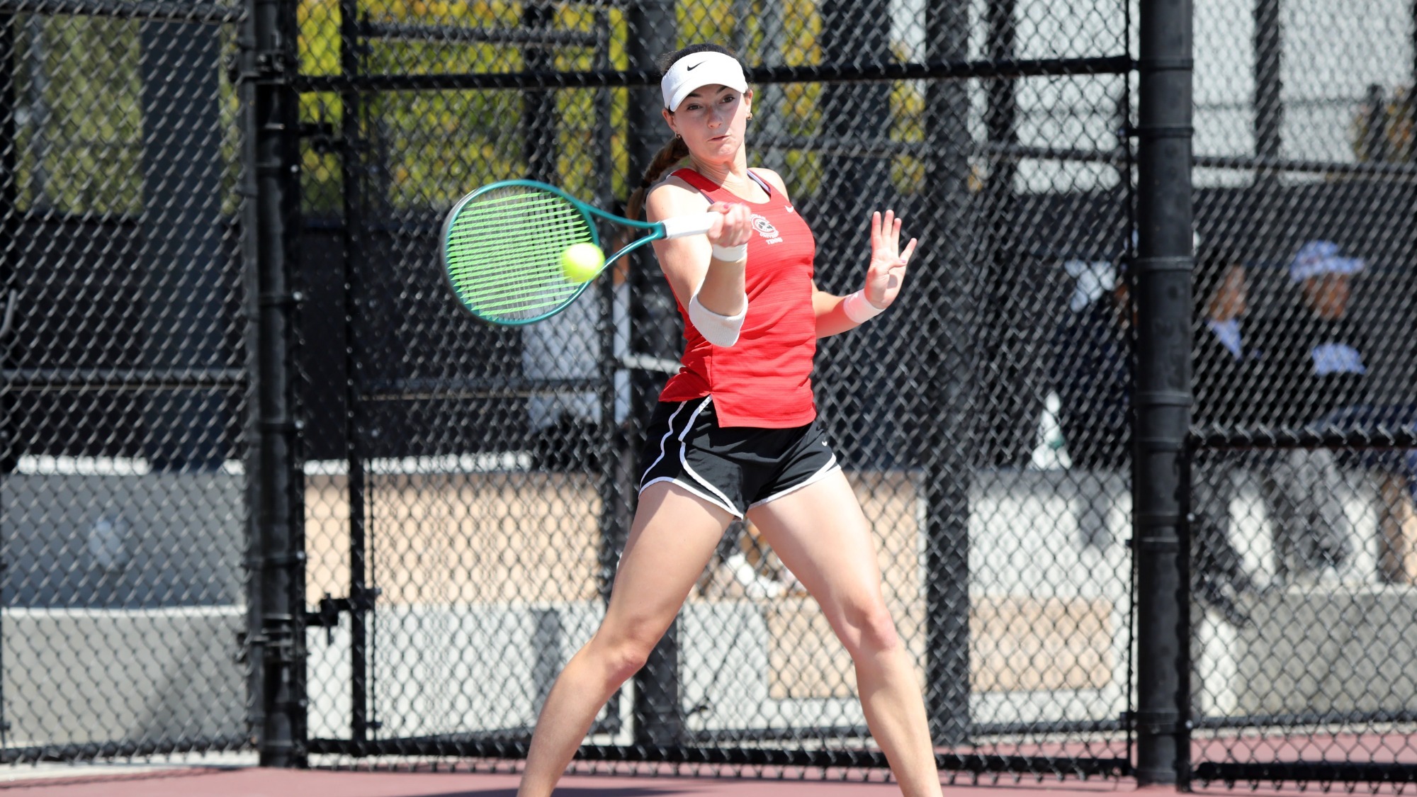 Lucy Erickson playing tennis.