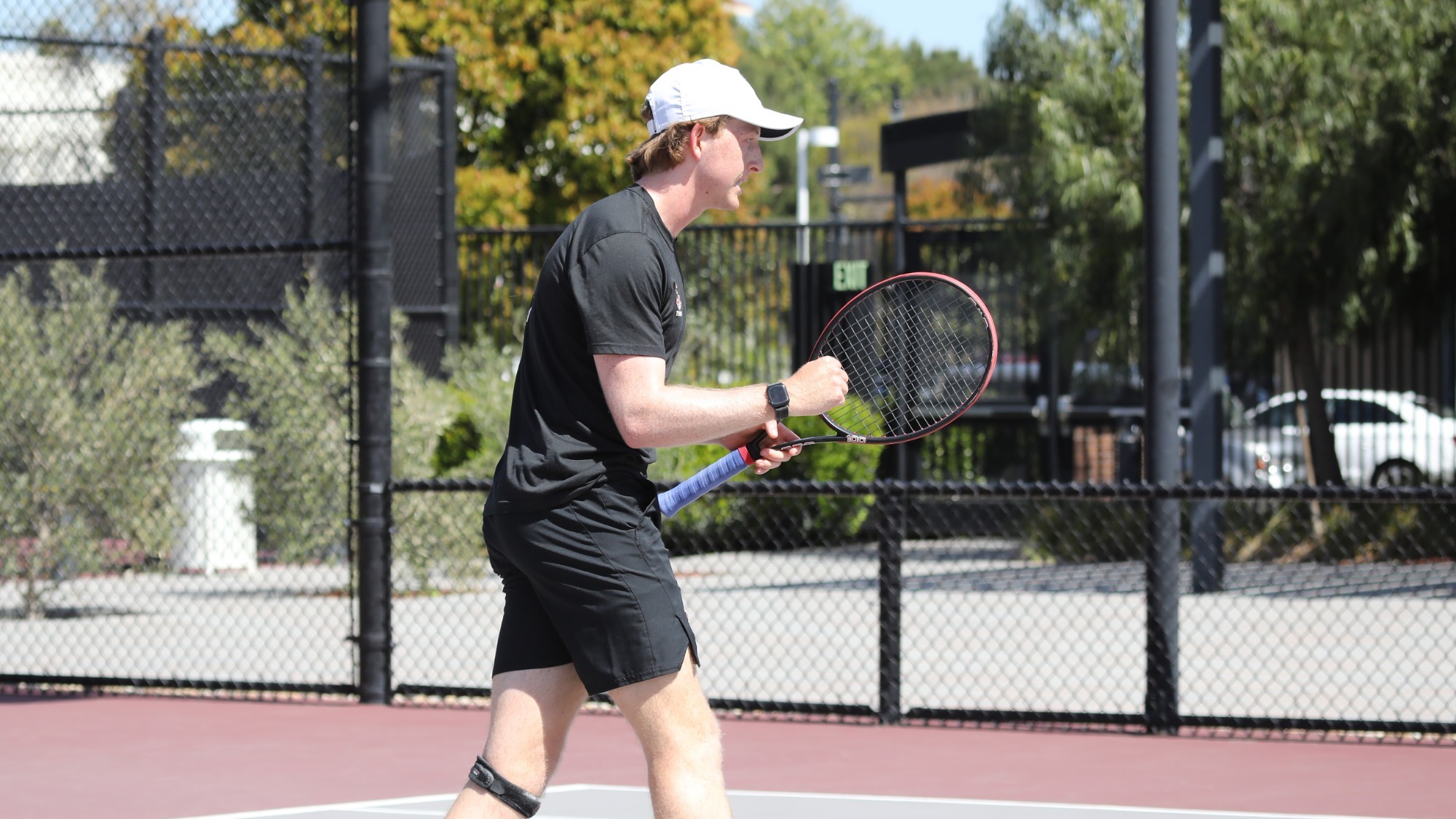 Caleb Wilkins celebrates winning a point on the tennis court.