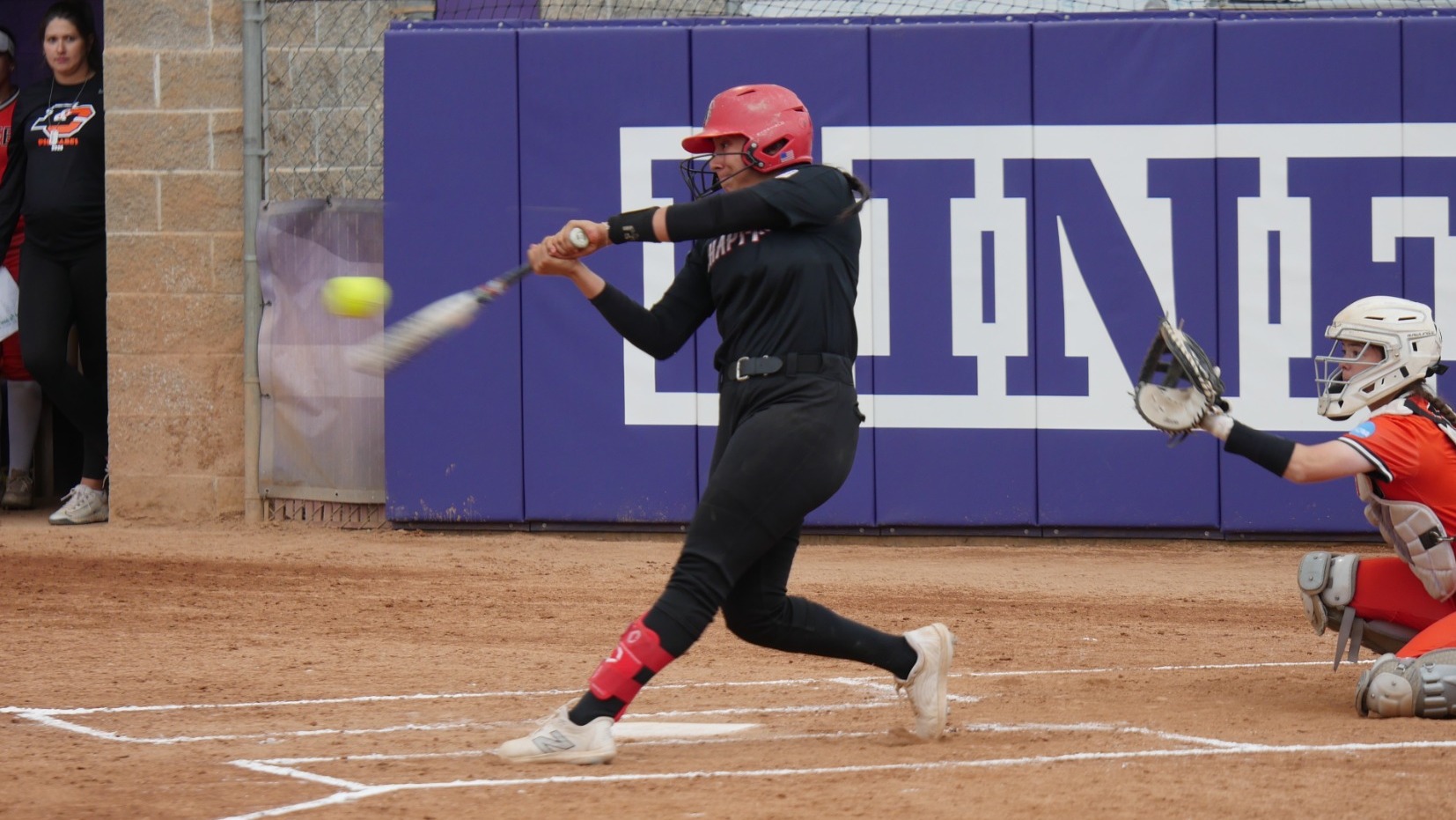 Ilianna Serna swings and hits the softball.