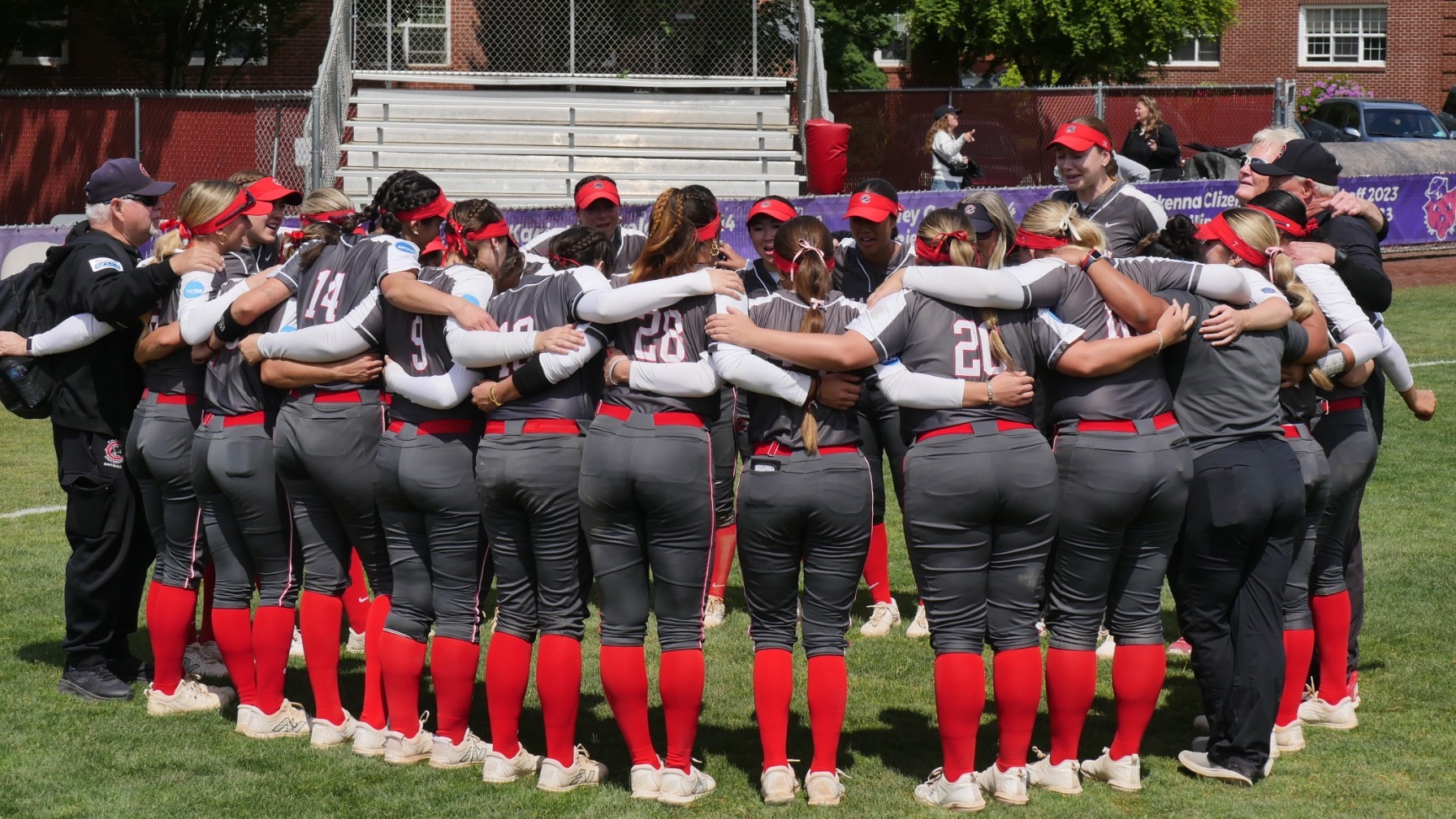 The softball team huddles after the game.
