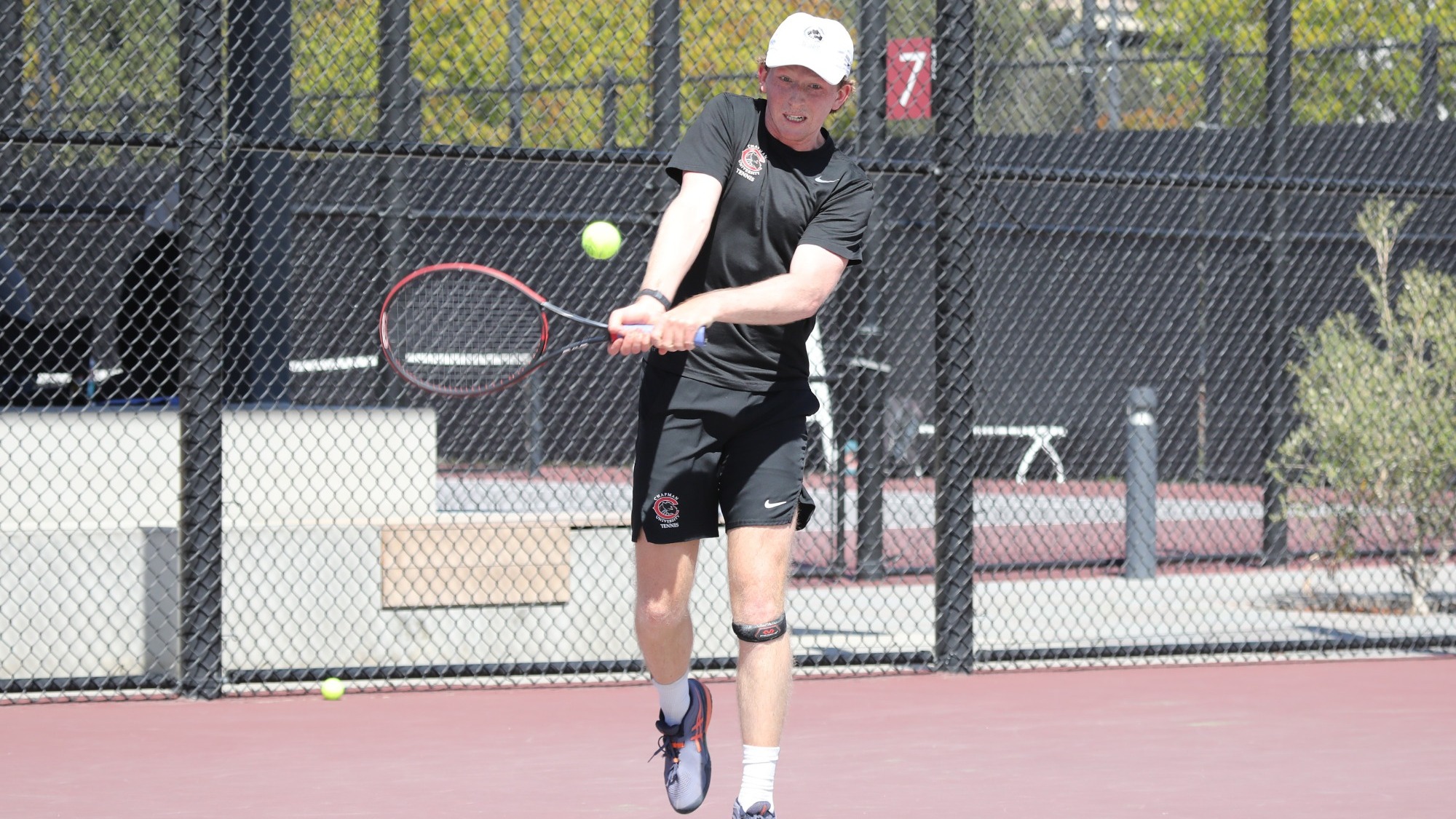 Caleb Wilkins playing tennis. 