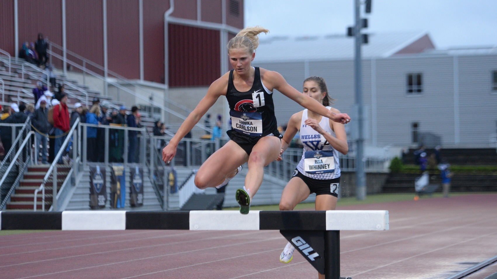 Annika Carlson jumps over the hurdle in the stteplechase.