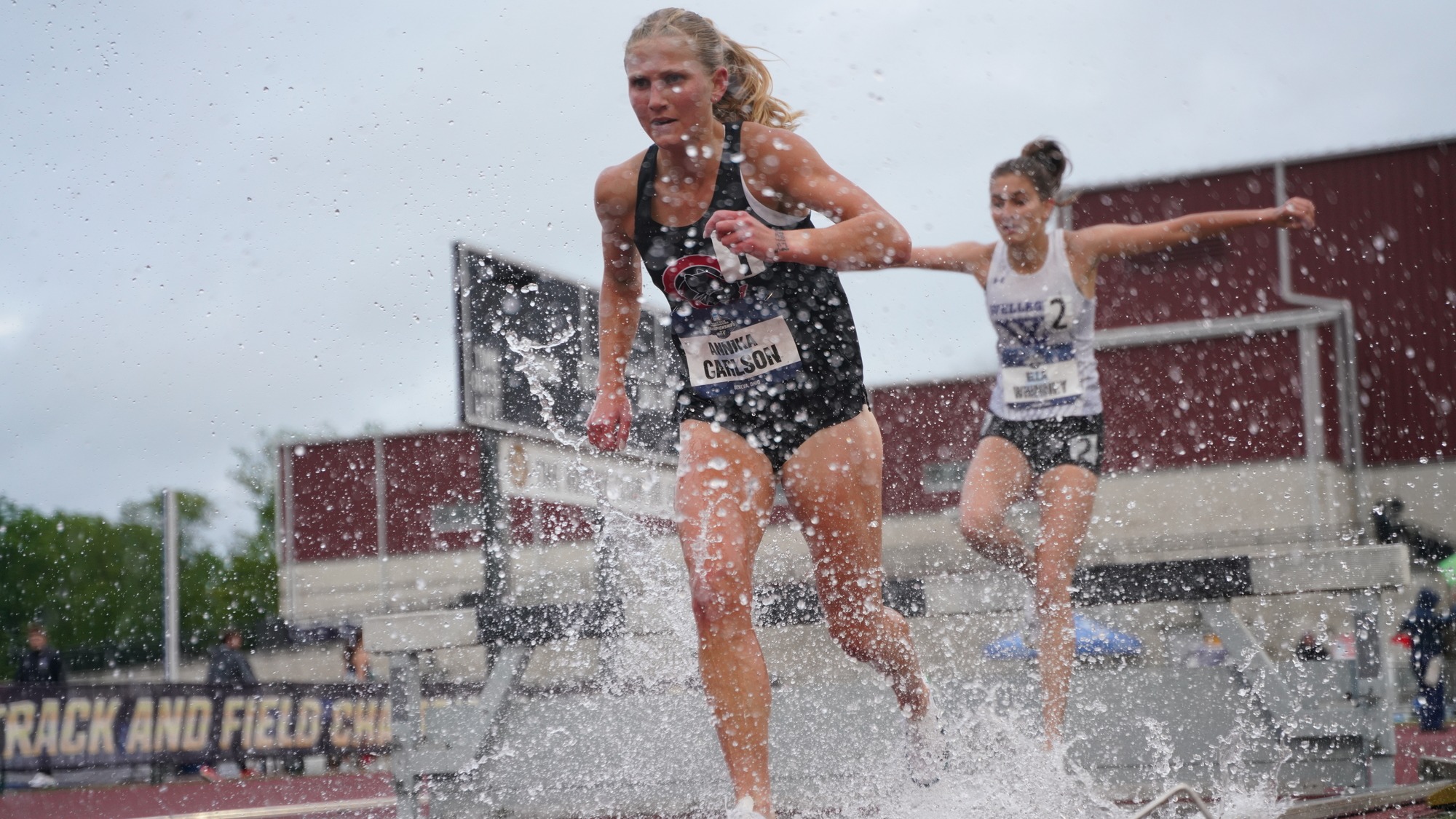 Annika Carlson jumps into the water during the steeplechase race.