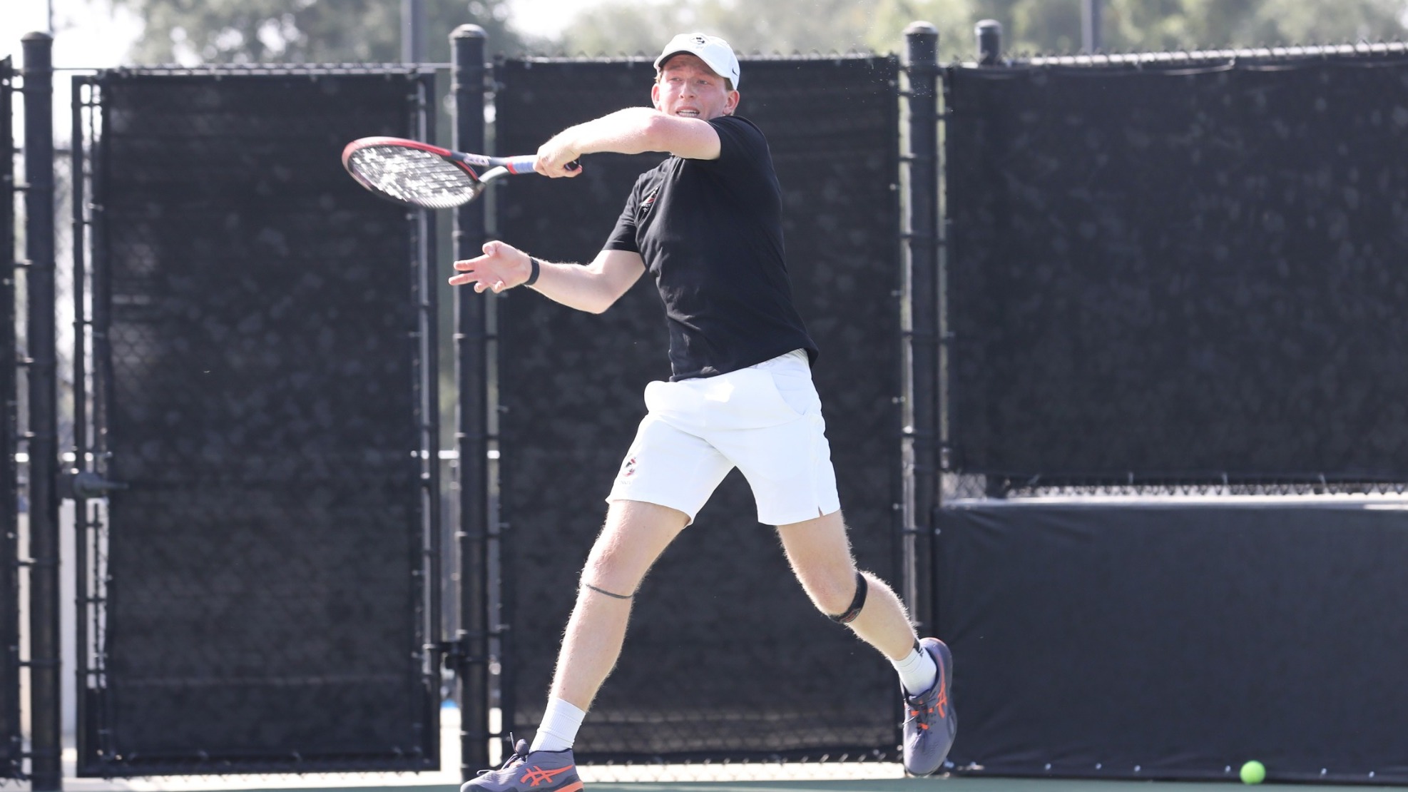 Caleb Wilkins playing tennis.