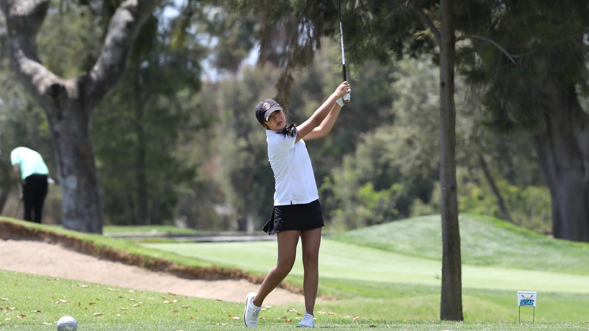 Kylie Nguyen watches her tee shot on the golf course.