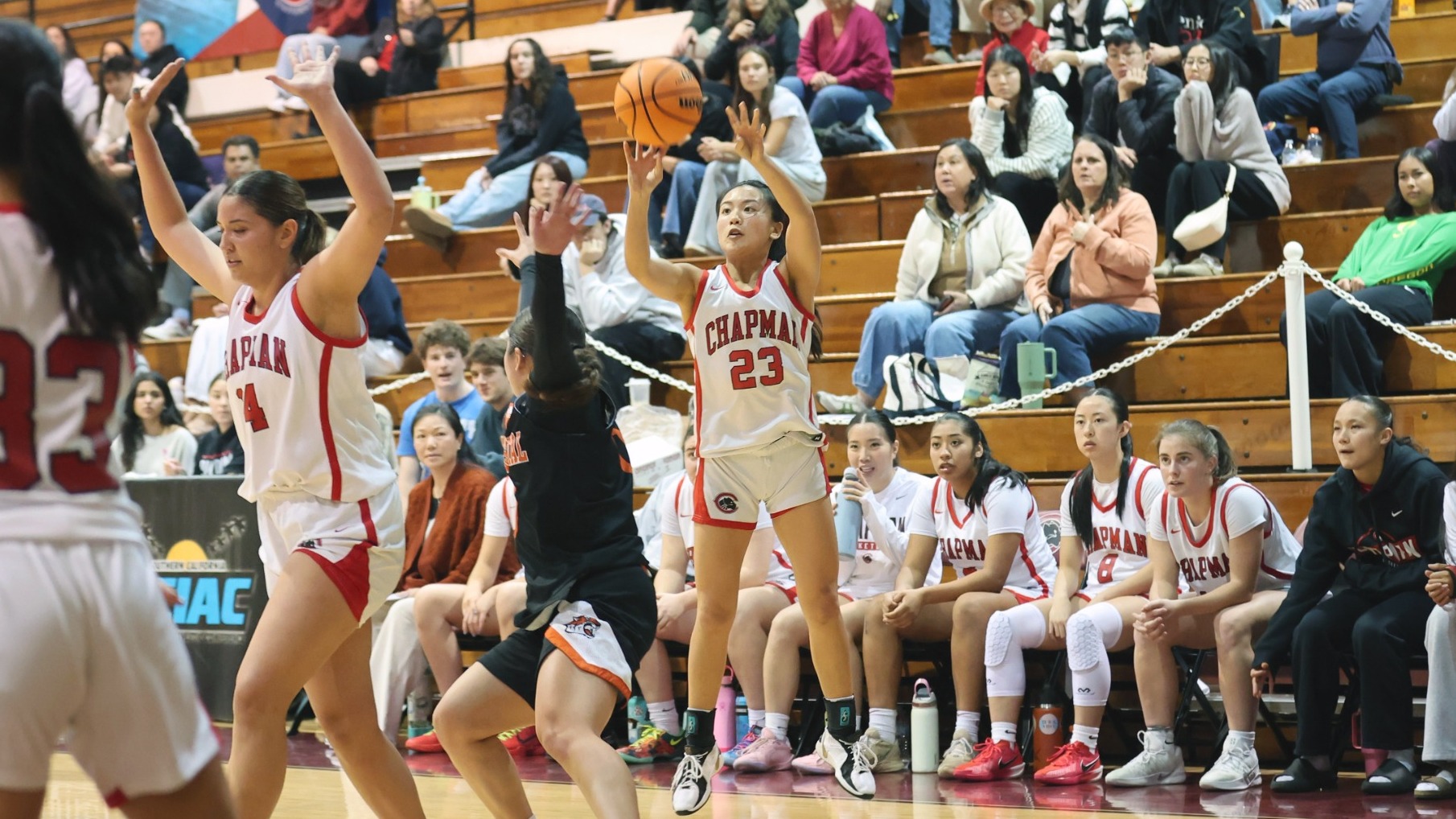 Maile Nakaji shoots a jump shot over a defender.