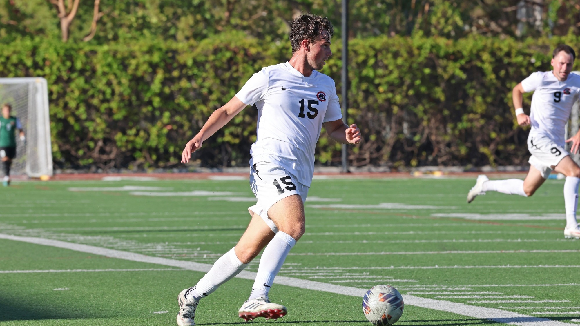 Evan White dribbles the soccer ball. 