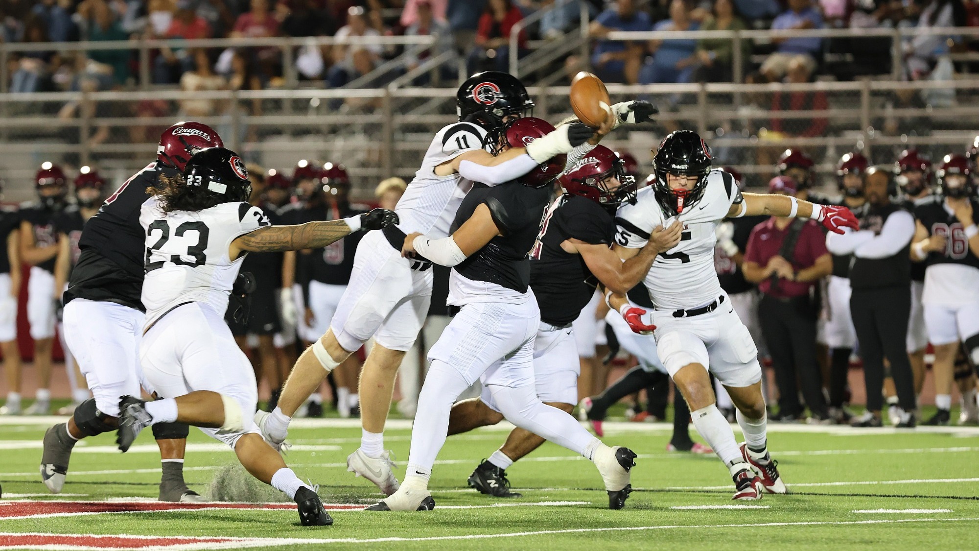 Colin Brophy tackles the quarterback as he tries to throw the ball.