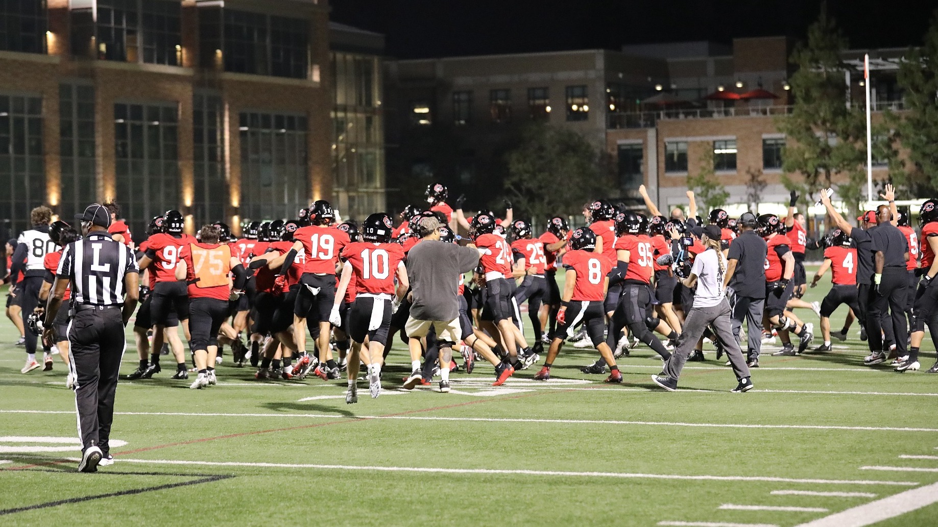 Chapman football players celebrate on the field.