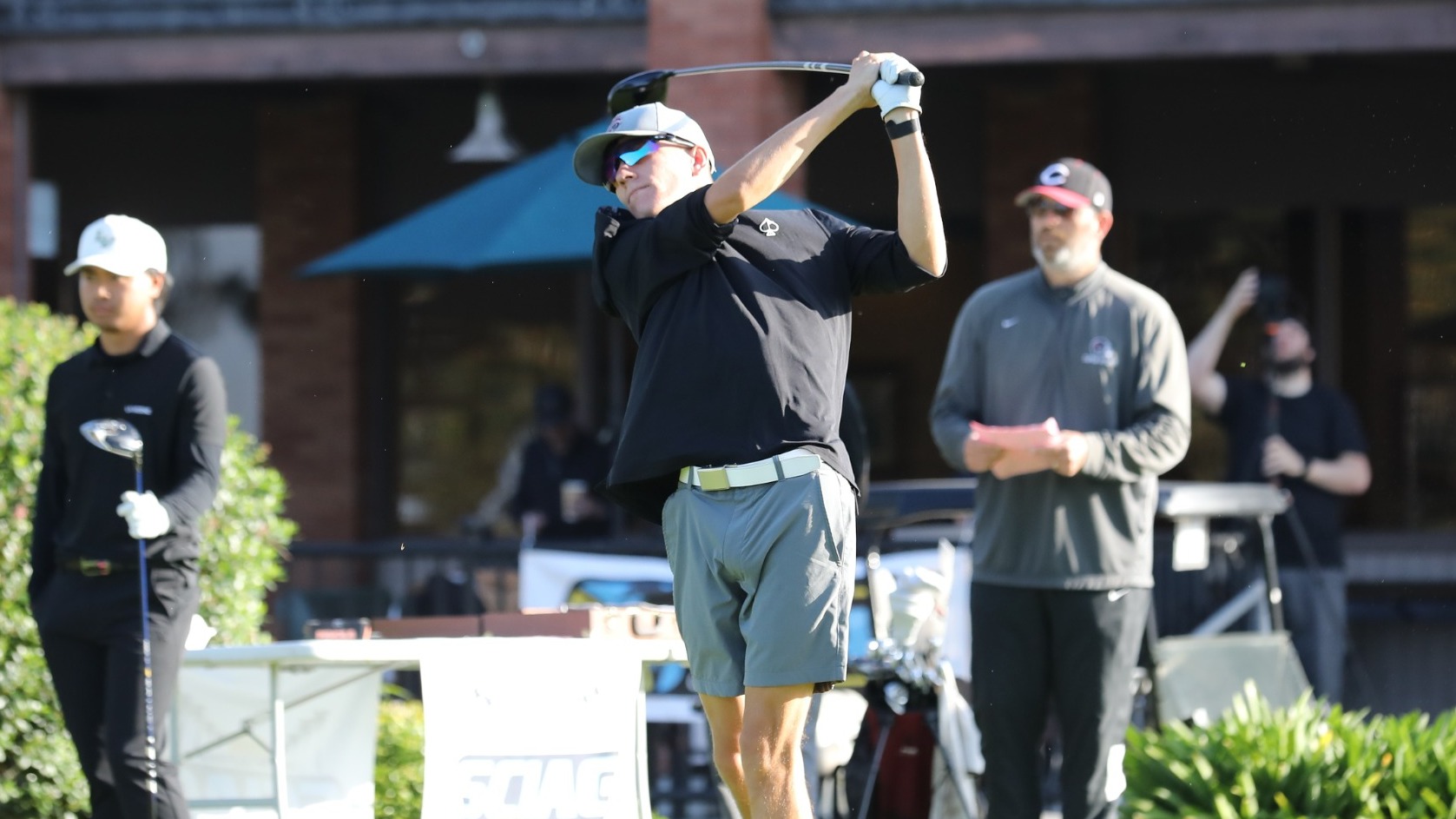 Conner Conley hits the golf ball off the first tee.