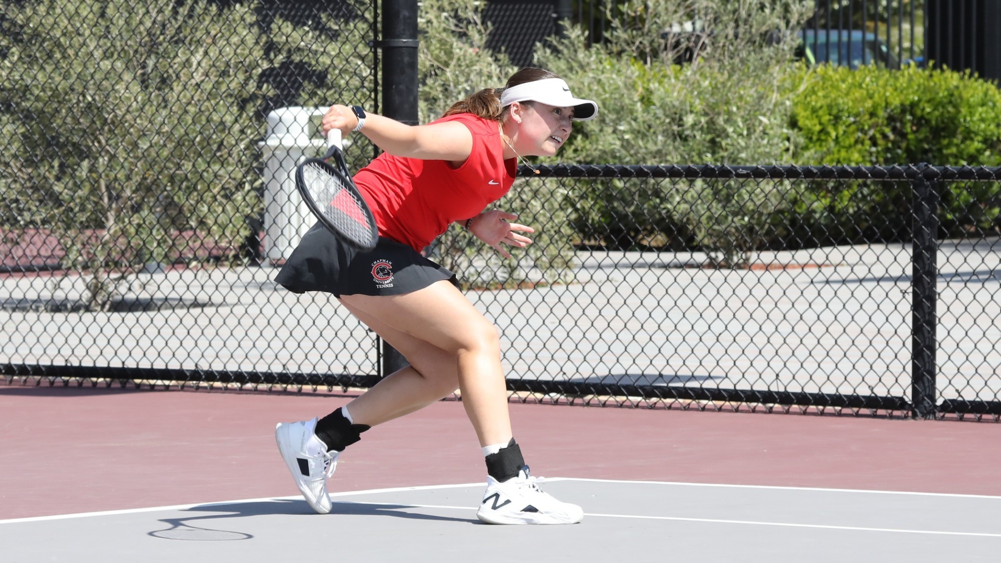 Lucy Wallin swings a racquet on the tennis court.