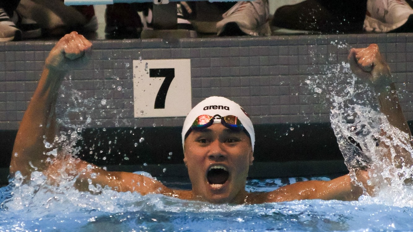 Ryan Musich celebrates after finishing a swimming race.