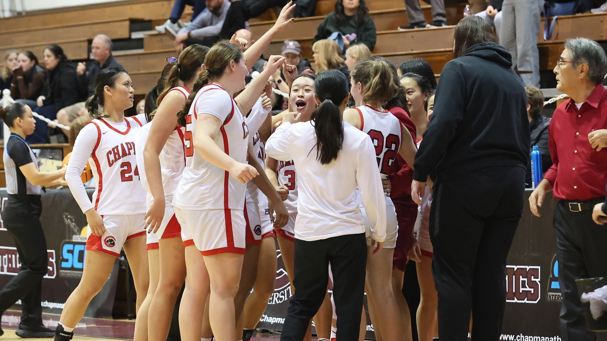 The women's basketball team huddles after a victory.