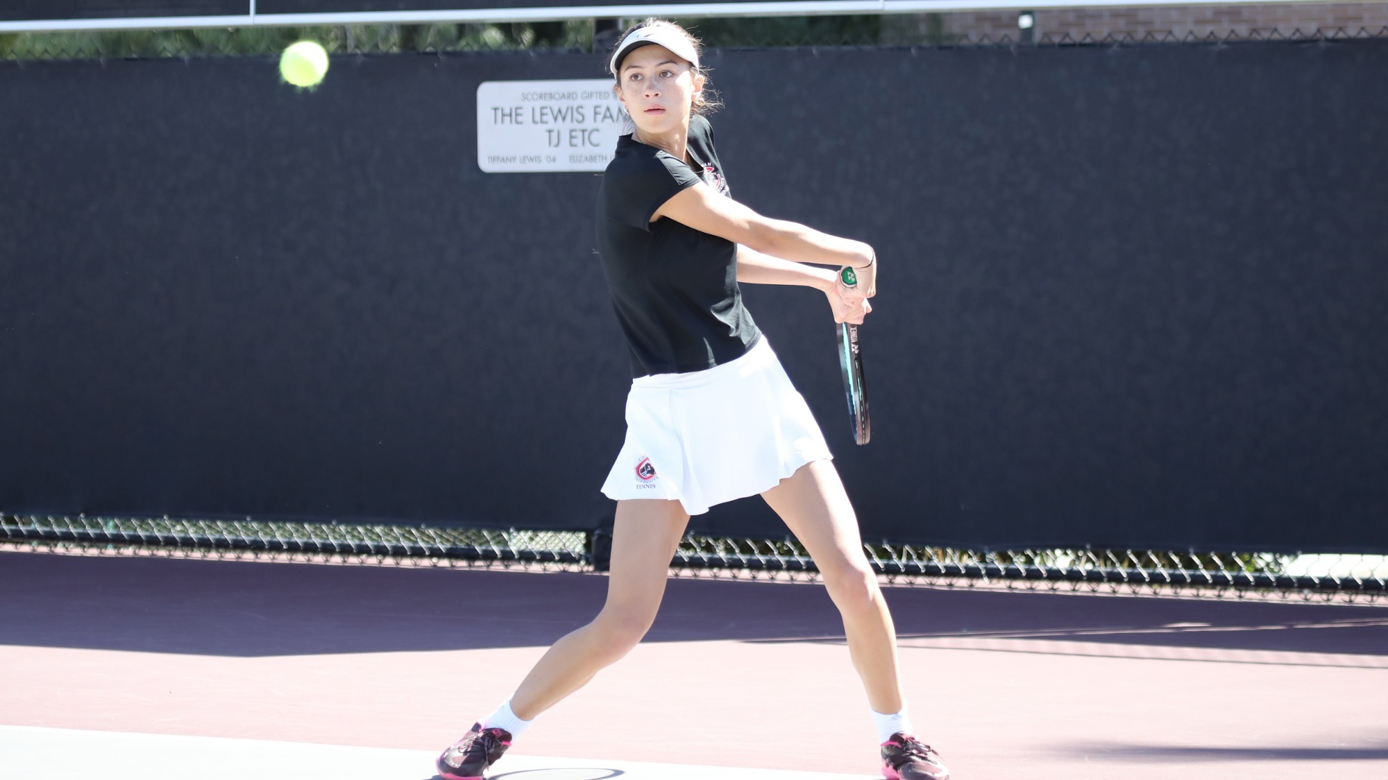 Malina Dahms prepares to hit the ball during a tennis match.