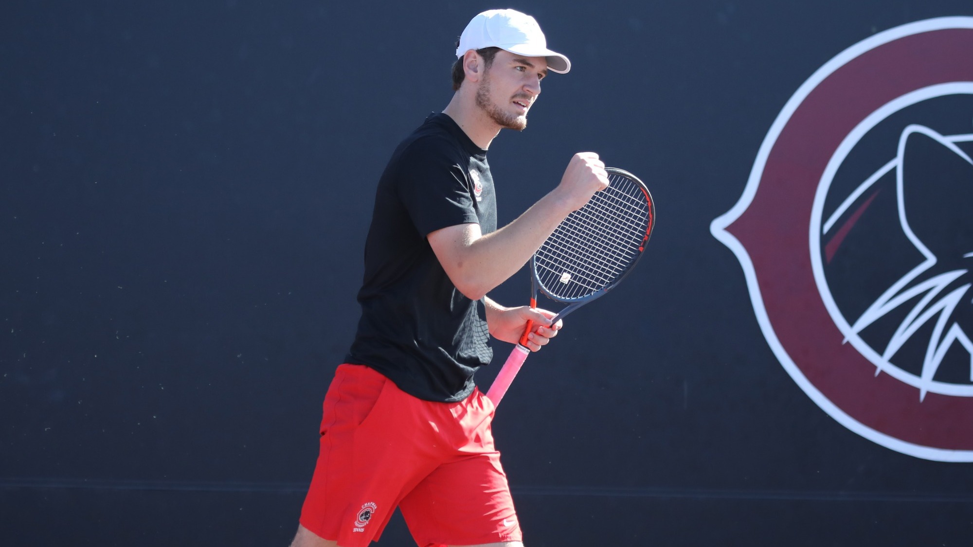 Lachlan Dickinson pumps his fist after winning a point.