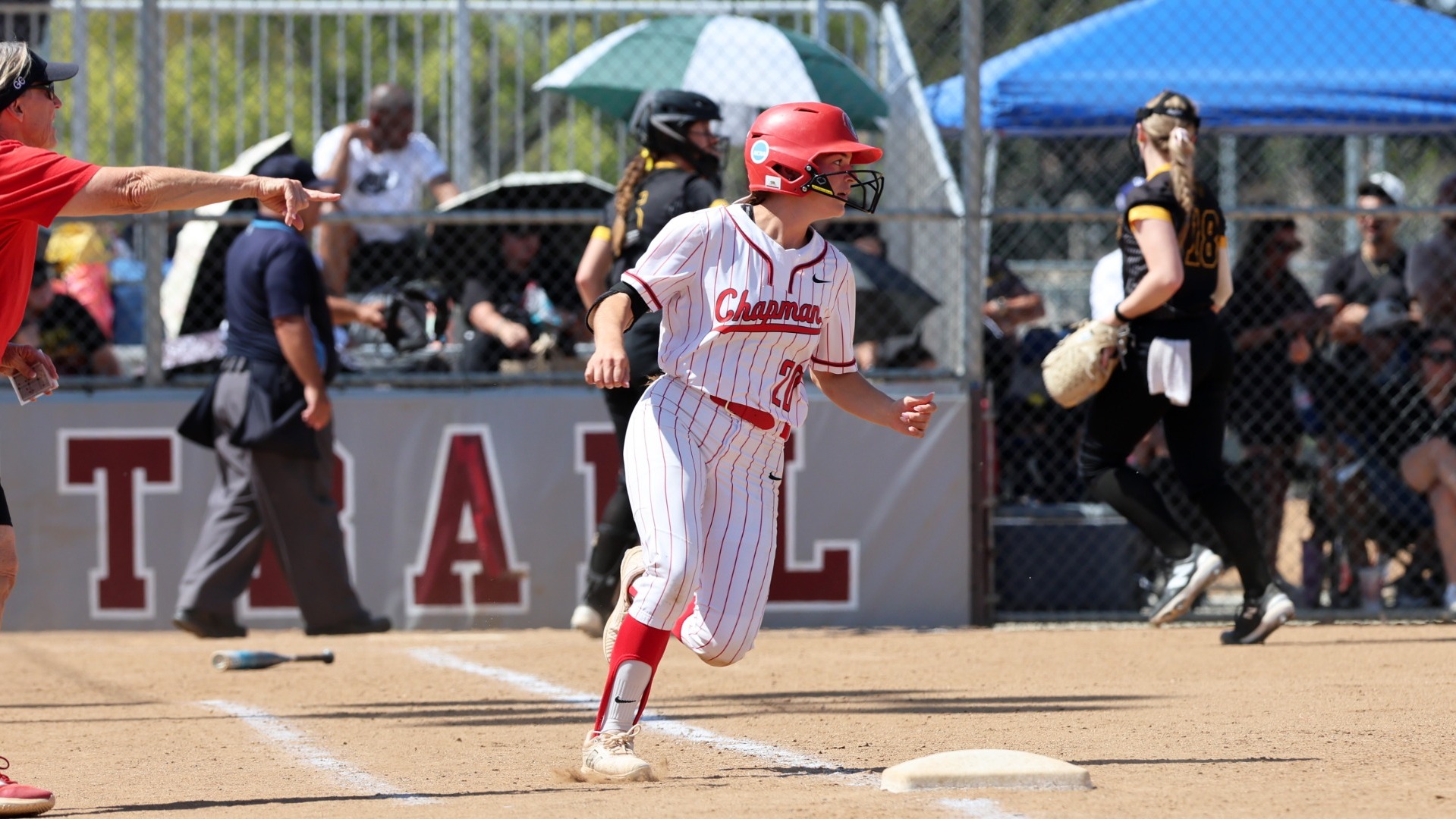 Mia Reyes runs to first base after hitting a single.