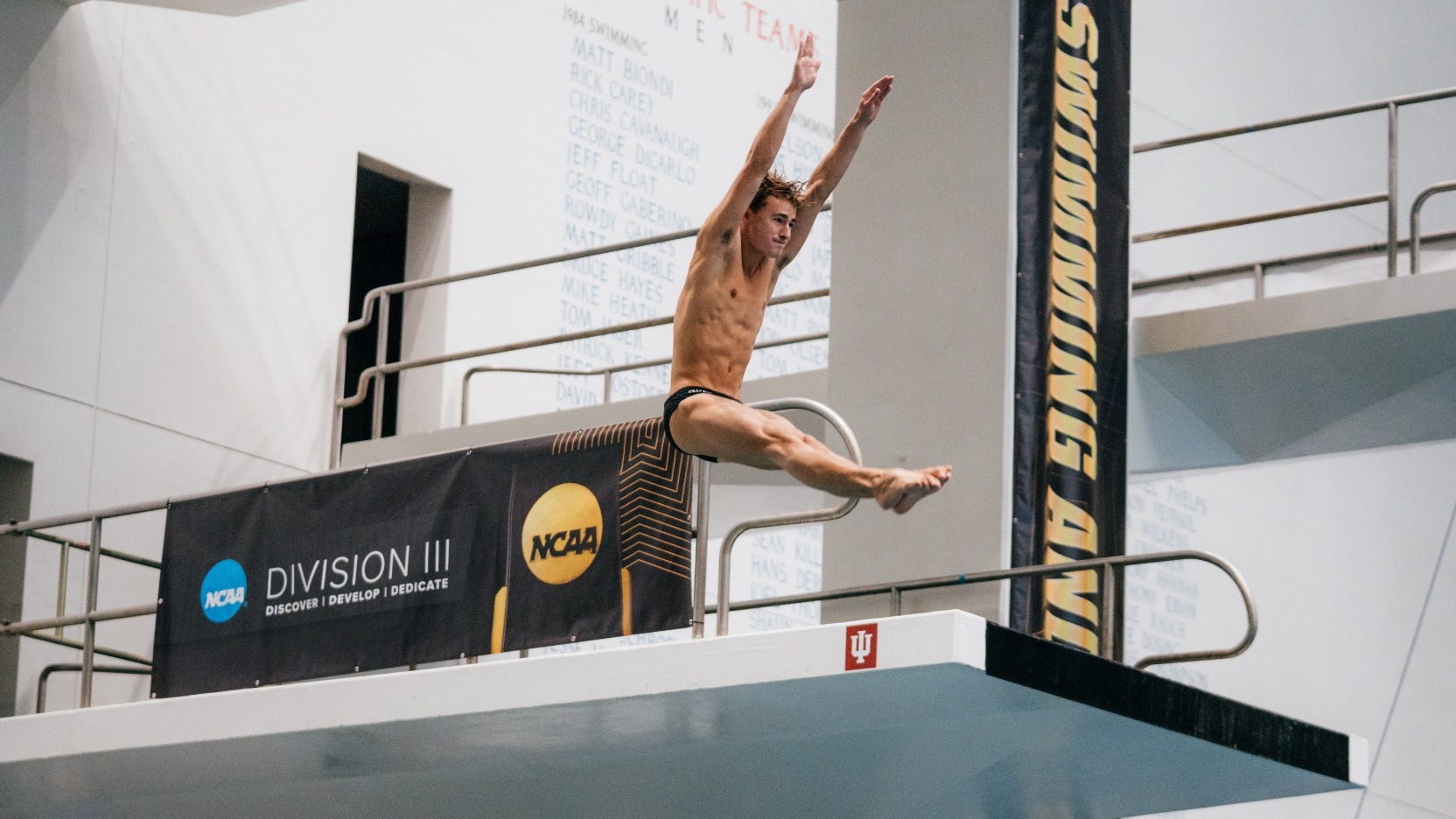 Reid Omilian performing a dive high in the air.