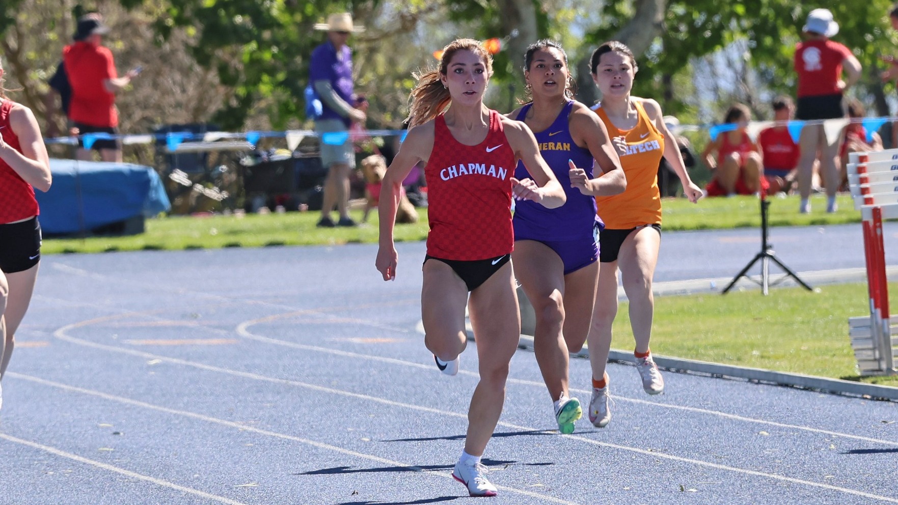 Makenna Lizarde sprints ahead of the competition on a track.