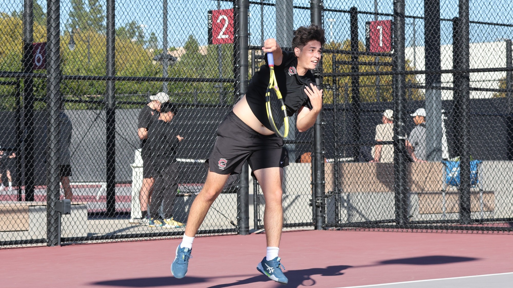 James Krantz serves the tennis ball to start a rally.