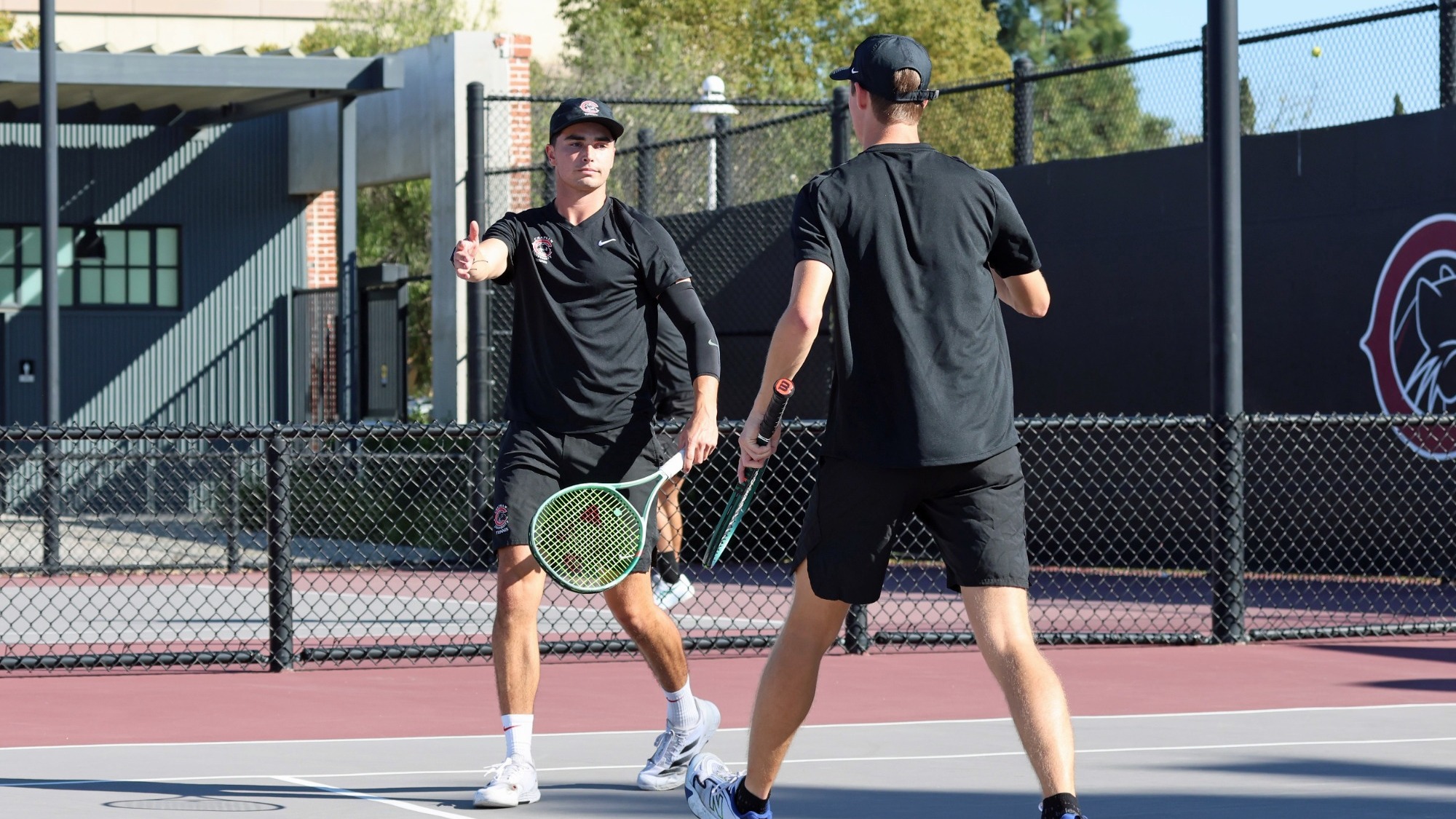 Ian Jordan high fives his doubles partner.