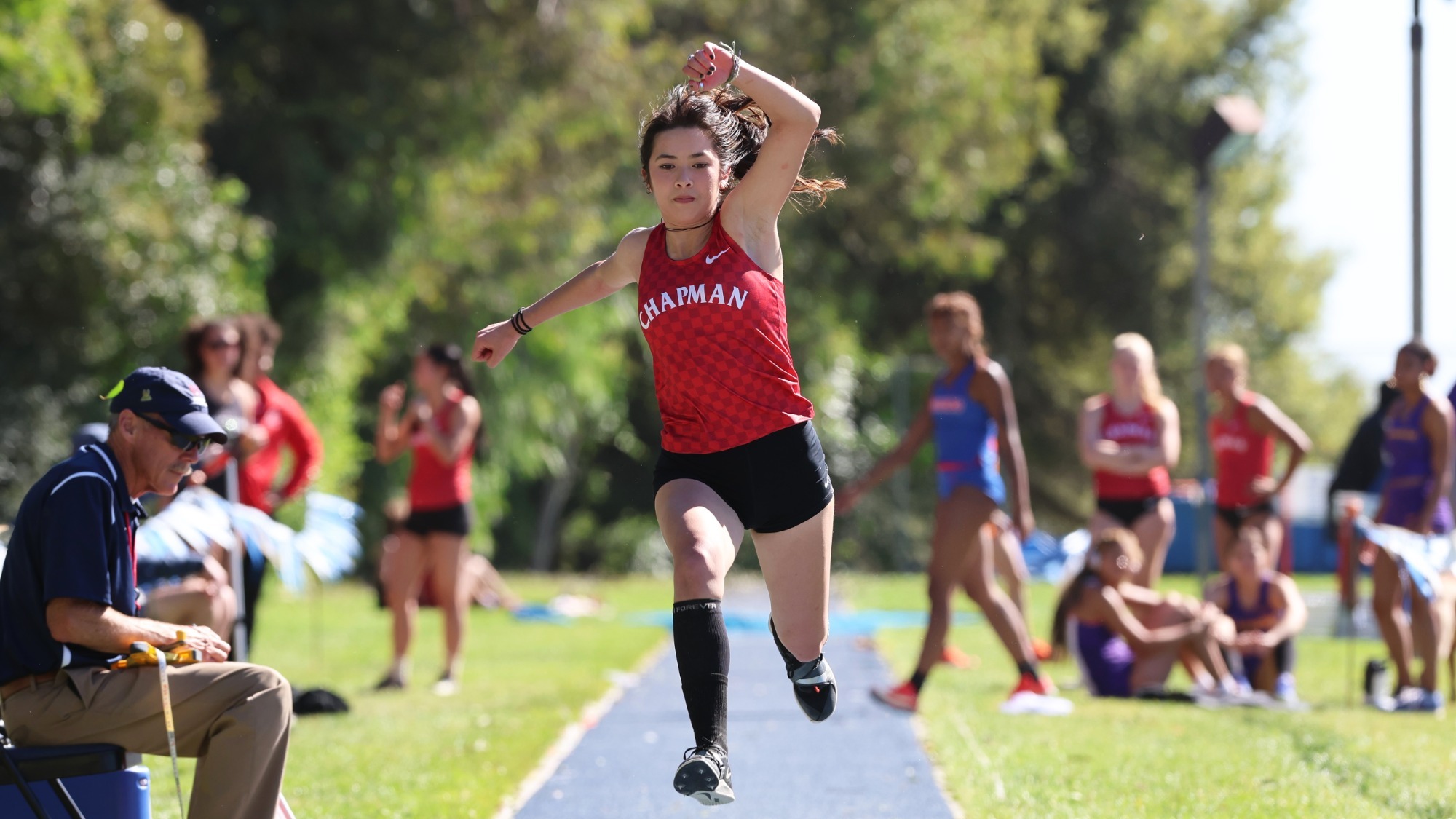 Lindsey Gray jumps up during a triple jump attempt.