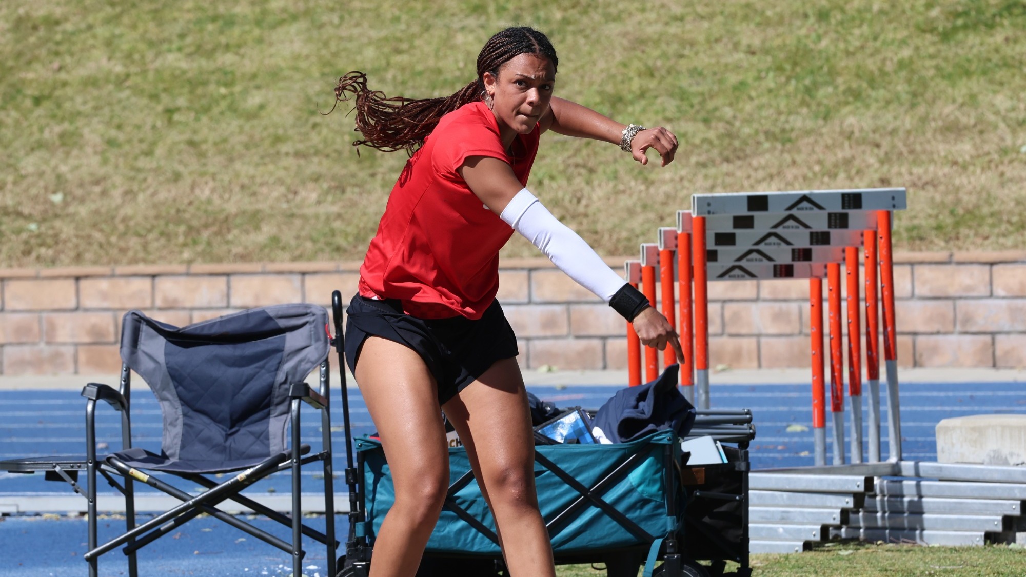 Eva Ndoye tosses the shot put.