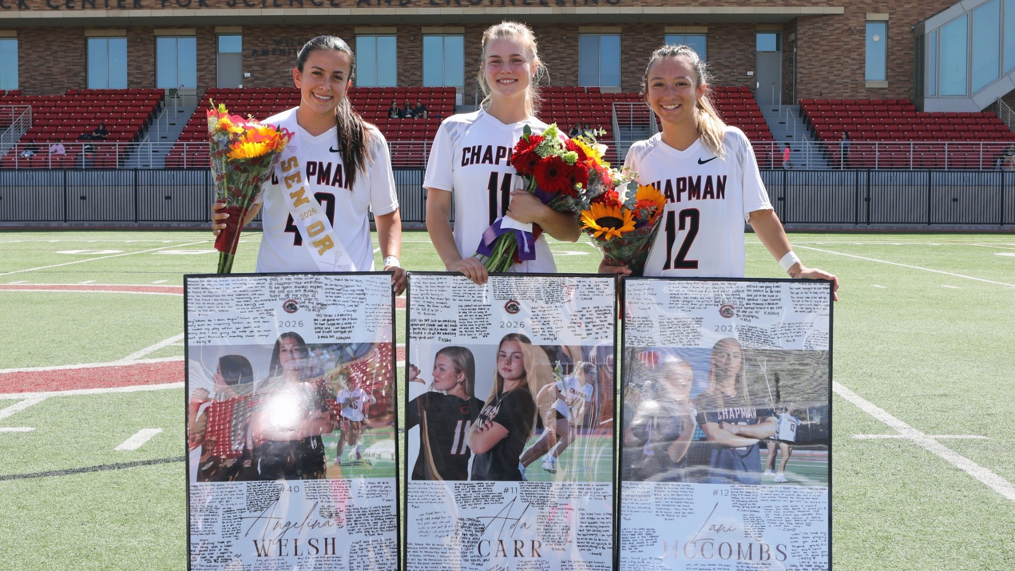 Women's lacrosse seniors hold up flowers and pictures to celebrate Senior Day.